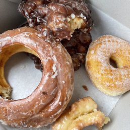 Half dozen custom: glazed honey bun, 2 fritters, sugar coated, French Cruller (devoured), Cake Donut (half eaten) Half dozen custom: glazed honey bun, 2 fritters, sugar coated, French Cruller (devoured), Cake Donut (half eaten)