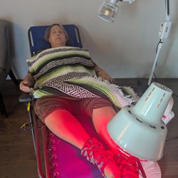 Boise Acupuncture Co-op - A patient peacefully resting with their needles and a heat lamp.