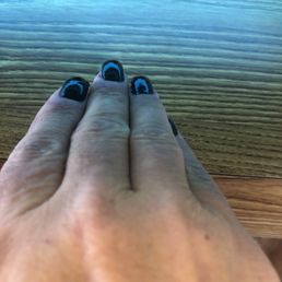 Close up green nails under purple