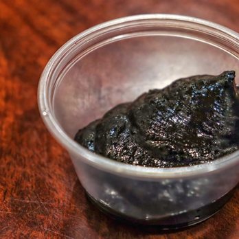 Zzamong - a black substance in a plastic container - Korean Near Me - Los Angeles, California