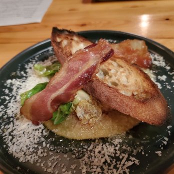 Pig in a Fur Coat - Yolk Filled Raviolo with bacon and crostini - New American Near Me - Madison, Wisconsin Pig in a Fur Coat - Yolk Filled Raviolo with bacon and crostini - New American Near Me - Madison, Wisconsin