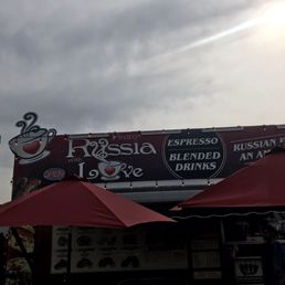 a coffee shop with red umbrellas