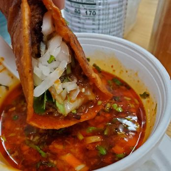 Mercado Marimar - Birra taco dipped into the soup.  So tasty!!! - Grocery Near Me - Madison, Wisconsin