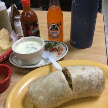 La Mexicana - a burrito supreme with some queso. A mandarin soda (with real cane sugar) in the background. - Mexican Near Me - Baton Rouge, Louisiana La Mexicana - a burrito supreme with some queso. A mandarin soda (with real cane sugar) in the background. - Mexican Near Me - Baton Rouge, Louisiana