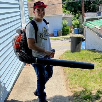 Raccoon Landscaping - a man carrying a blower - Landscaping Near Me - Norwich, Connecticut Raccoon Landscaping - a man carrying a blower - Landscaping Near Me - Norwich, Connecticut