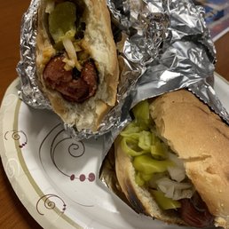 Half eaten beef dog w/pickle spears, onions, jalapeños, Also a polish w/pepperoni, onion, kraut. Half eaten beef dog w/pickle spears, onions, jalapeños, Also a polish w/pepperoni, onion, kraut.