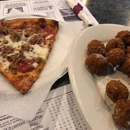 a slice of pizza and fried chicken nuggies a slice of pizza and fried chicken nuggies