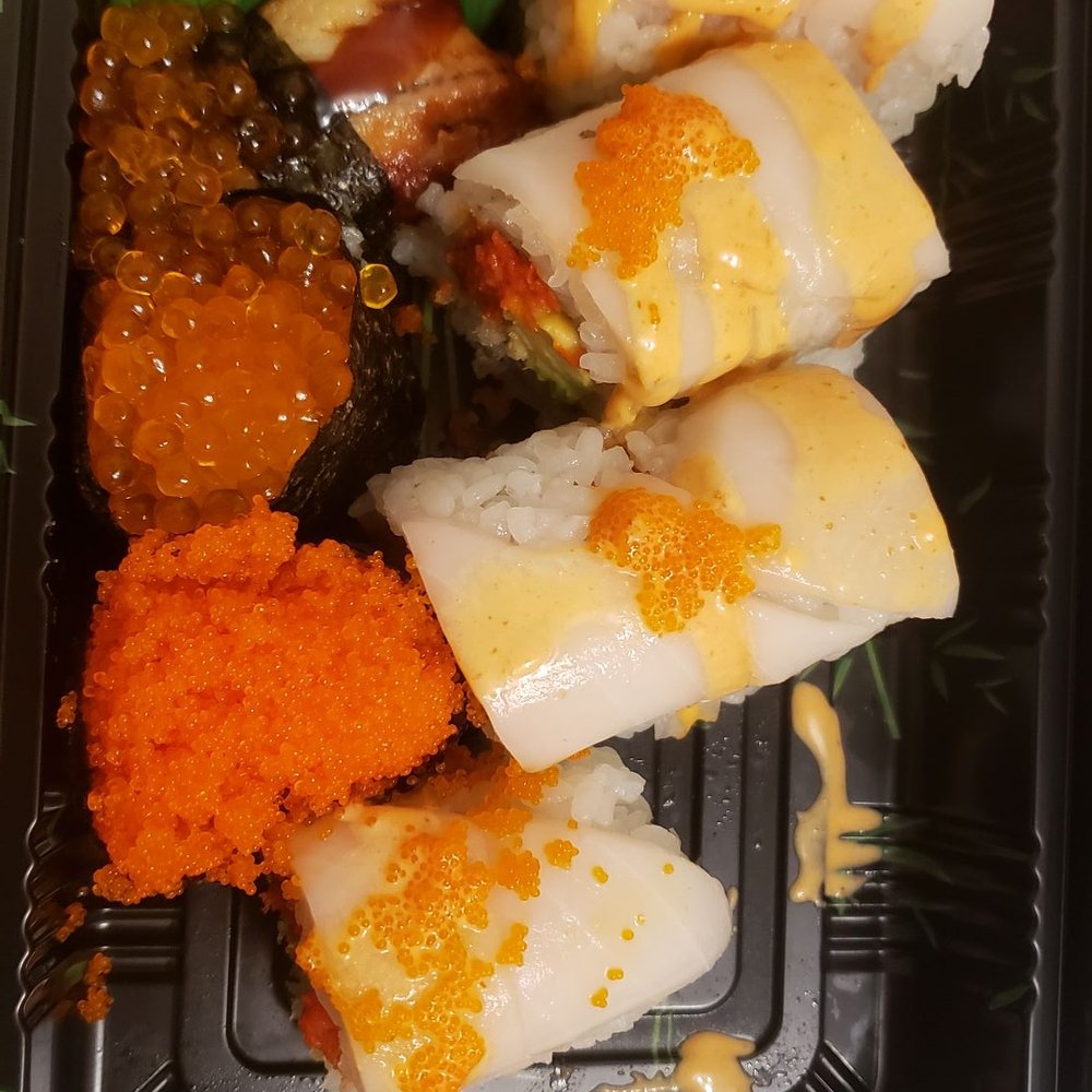 a tray of sushi and vegetables a tray of sushi and vegetables