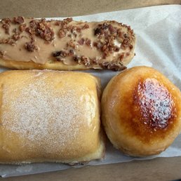 A Pillow donut, a chai donut and a maple bacon bar. A Pillow donut, a chai donut and a maple bacon bar.