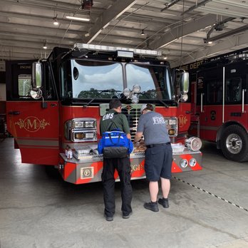 Big Mikes BBQ - two men working on a fire truck - Southern Near Me - Cary, North Carolina