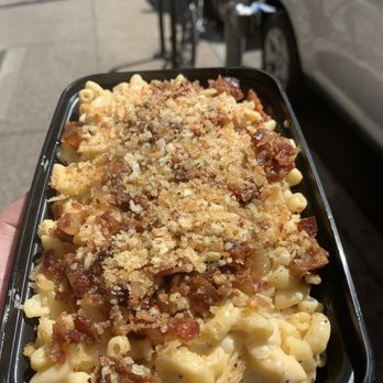 Mac Mart - a hand holding a container of macaroni and cheese - American Near Me - Philadelphia, Pennsylvania