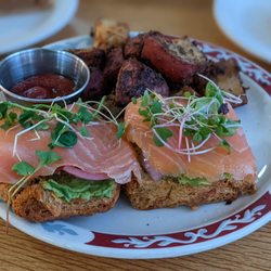 Dough Mama - salmon lox and avocado with pickled onions on a biscuit with flavorful potatoes