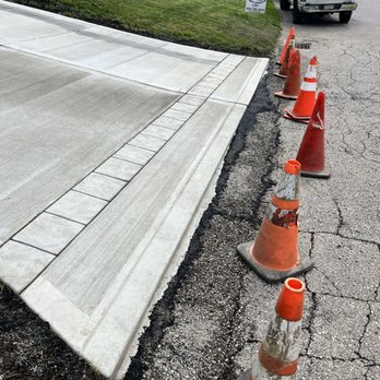 R.K. Concrete & Construction - a row of cones on the side of a road - Masonry/Concrete Near Me R.K. Concrete & Construction - a row of cones on the side of a road - Masonry/Concrete Near Me