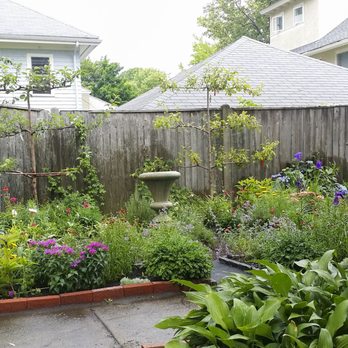 Gardens By Suniti - a garden with a fence and a birdbath - Landscaping Near Me Gardens By Suniti - a garden with a fence and a birdbath - Landscaping Near Me