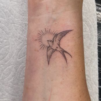 Ink Therapy Studio - Tattoo of a bird flying by the sun. - Tattoo Near Me