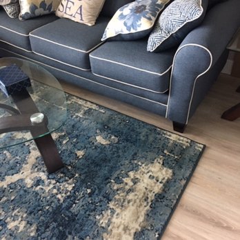 KC Tile Restoration - a living room with a couch and a coffee table - Flooring Near Me - Boynton Beach, Florida