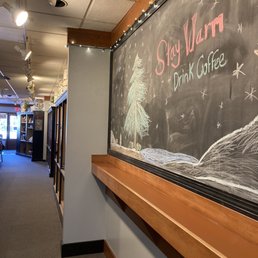 Side wall includes merch, across from some seating and the specially scooped/ground teas and coffee beans to go.