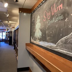 Daybreak Coffee Roasters - Side wall includes merch, across from some seating and the specially scooped/ground teas and coffee beans to go.