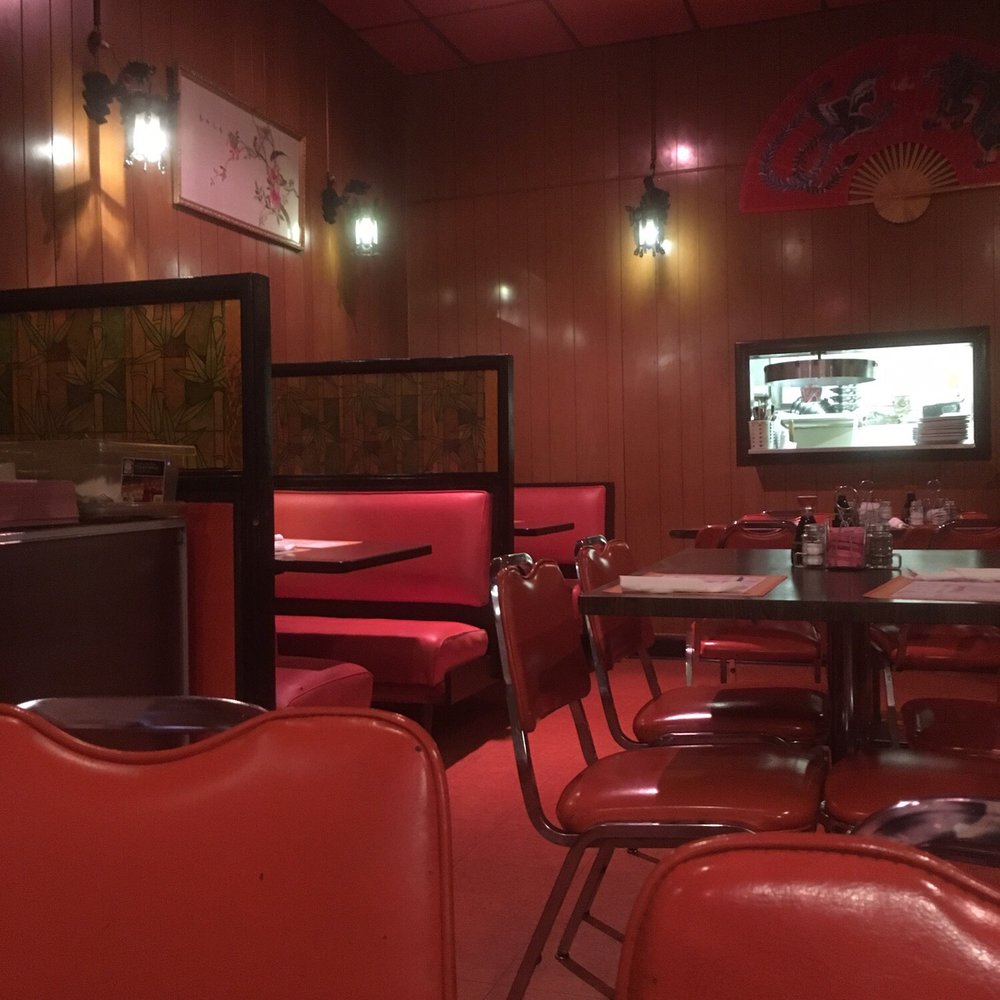 a restaurant with red booths and tables