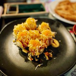 Mootone Fine Japanese Cuisine - Volcano Maki - Lightly fried California maki topped with spicy crabmeat, eel sauce, and tobiko.