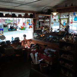 Not best view but immediately to left entering store with hats against front windows