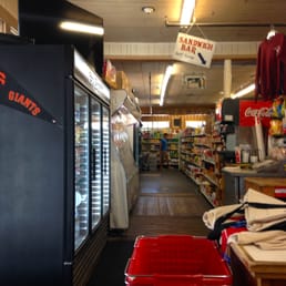 Inside to the left of the store.