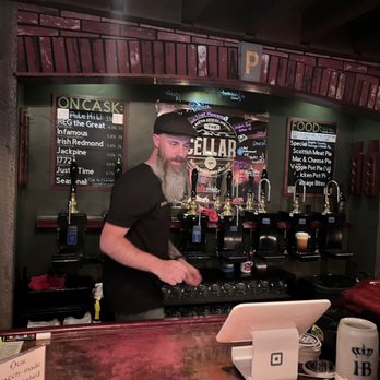The Cellar - a man standing at a bar - Pubs Near Me - Bend, Oregon