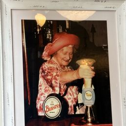 Queen on the wall pouring a beer, iconic.