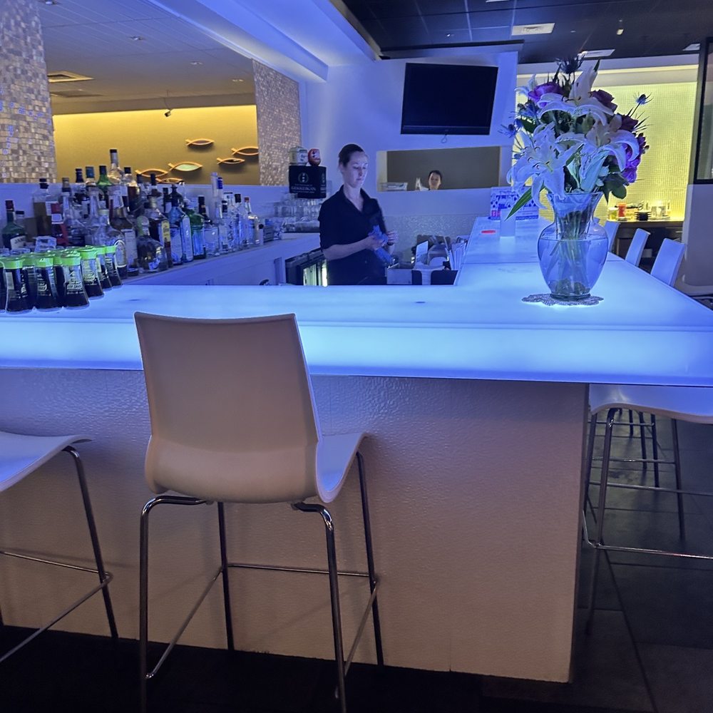 Mizuno Japanese Restaurant - a bar with a vase of flowers on the counter - Japanese Near Me - Virginia Beach, Virginia Mizuno Japanese Restaurant - a bar with a vase of flowers on the counter - Japanese Near Me - Virginia Beach, Virginia