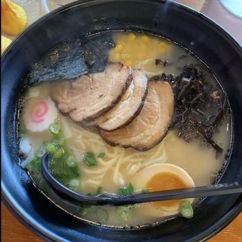 Bowl Plus - Tonkotsu Shoyu - A bowl of ramen featuring sliced pork, half a boiled egg, green onions, seaweed, and black fungus in a creamy broth, with noodles visible beneath. - Ramen Near Me - Springfield, Illinois
