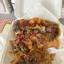 a plate of nachos and a fork a plate of nachos and a fork