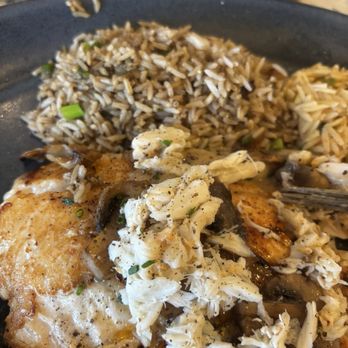 Landry's Seafood House - Red snapper topped with crab. Meat with dirty rice . - Seafood Near Me - Katy, Texas Landry's Seafood House - Red snapper topped with crab. Meat with dirty rice . - Seafood Near Me - Katy, Texas
