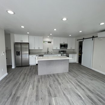 Backyard Estates - Completed living room with kitchen appliances and split system hvac. - General Contractors Near Me - Upland, California