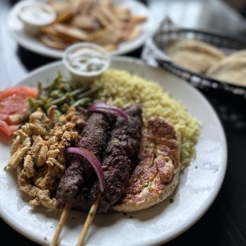 Zayna Mediterranean - a plate of food on a table - Mediterranean Near Me - Tucson, Arizona Zayna Mediterranean - a plate of food on a table - Mediterranean Near Me - Tucson, Arizona