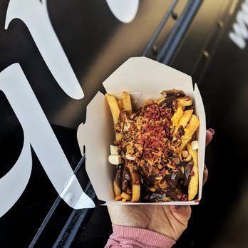 Grilldudes - a hand holding a box of fries - Food Trucks Near Me - Toronto, Ontario Grilldudes - a hand holding a box of fries - Food Trucks Near Me - Toronto, Ontario