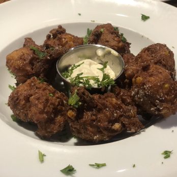Twenty Two North Holland - Summer corn and blue crab fritters with charred Serrano pepper aioli. - Bars Near Me - Bellville, Texas Twenty Two North Holland - Summer corn and blue crab fritters with charred Serrano pepper aioli. - Bars Near Me - Bellville, Texas