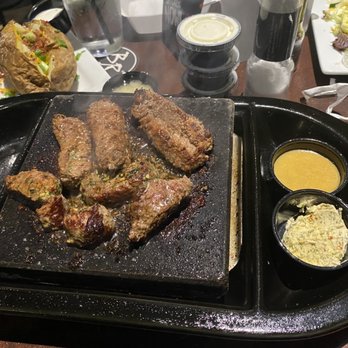 Black Rock Bar & Grill - Signature Black Rock Sirloin cooking on the extremely hot volcanic rock - American Near Me - Novi, Michigan Black Rock Bar & Grill - Signature Black Rock Sirloin cooking on the extremely hot volcanic rock - American Near Me - Novi, Michigan