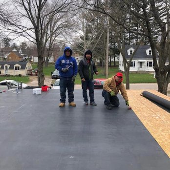 Manny's Eastern Iowa Roofing and Construction - two men working on a flat roof - Roofing Near Me - Marion, Iowa