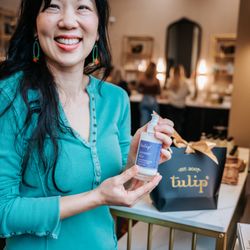 Tulip - Woman showing us bottle of lotion.