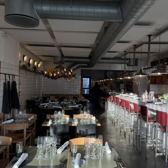 Fleisch - Sunlight pouring into Restaurant Fleisch in Copenhagen's Meatpacking District, with set tables and an open bar ready for the evening. - Steakhouses Near Me - Copenhagen, 84