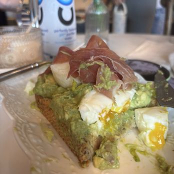 Glimmer Cafe - My Prosciutto & Poached Eggs Avocado Toast (sans the arugula) --so good & nice size portion with a lot of avocado!!! - Cafes Near Me - Delray Beach, Florida Glimmer Cafe - My Prosciutto & Poached Eggs Avocado Toast (sans the arugula) --so good & nice size portion with a lot of avocado!!! - Cafes Near Me - Delray Beach, Florida