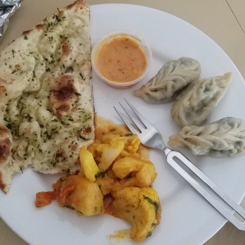 Everest  Restaurant - Garlic basil naan, veg momo, Alu cauliflower. Excuse the plating,  I dished it out of Togo containers at home! - Indian Near Me - Petaluma, California