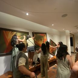 Poorly hung paintings falling on us as we tried to take a group photo Poorly hung paintings falling on us as we tried to take a group photo