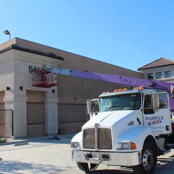 Purple Crane Services - Using a 2-person manbasket attached to our 22-ton Manitowoc boom truck, we installed a business sign in Riverside, CA. - Crane Services Near Me - Pomona, California