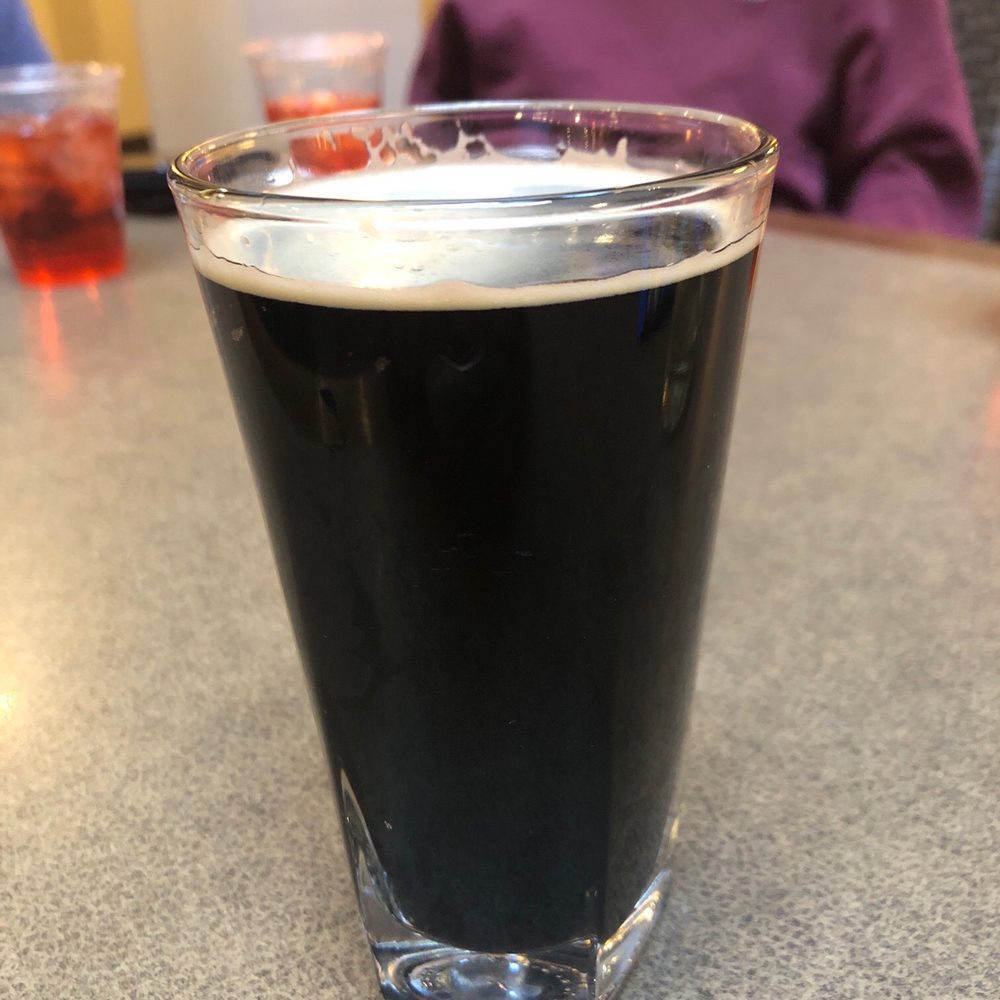 a glass of beer on a table a glass of beer on a table
