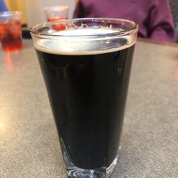 a glass of beer on a table a glass of beer on a table