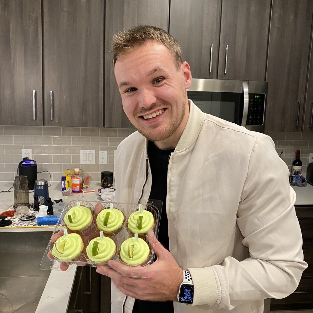 Hope Haus Bakery - a man holding a tray of cupcakes - Bakeries Near Me Hope Haus Bakery - a man holding a tray of cupcakes - Bakeries Near Me