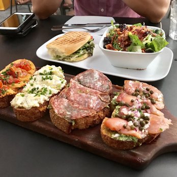 Postino Arcadia - Bruschetta ($15 - hummus and tomato, artichoke dip, salami pesto, salmon pesto) + half turkey panini with Brussel sprouts salad ($11.50) - Wine Bars Near Me - Phoenix, Arizona Postino Arcadia - Bruschetta ($15 - hummus and tomato, artichoke dip, salami pesto, salmon pesto) + half turkey panini with Brussel sprouts salad ($11.50) - Wine Bars Near Me - Phoenix, Arizona