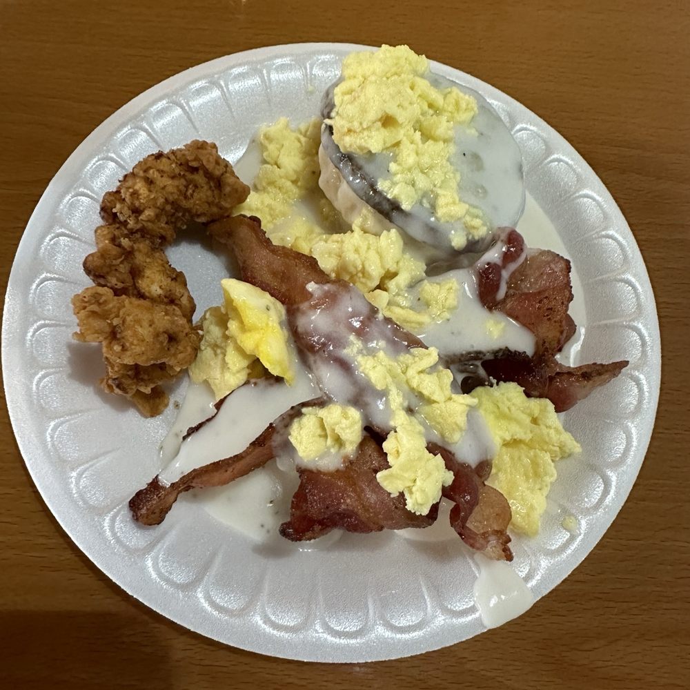 Red Barn Cafe - Biscuit, sausage, bacon, and chicken strips covered in gravy.... That's the good - Salad Near Me - Coldwater, Mississippi