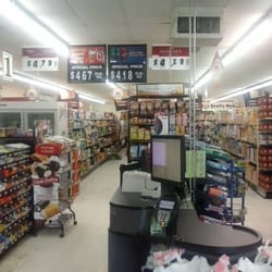 Right side of store features can goods, dairy, cheese. Meat in the far back.